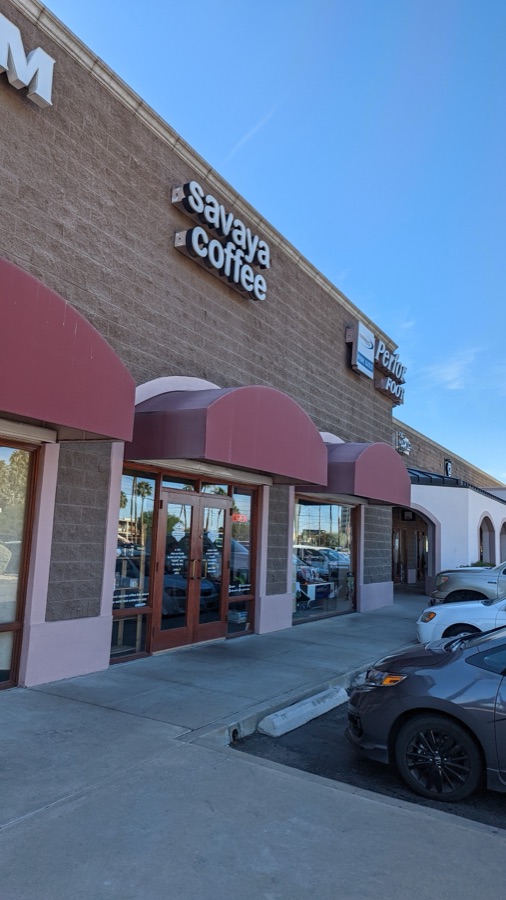 The Savaya storefront on East Broadway with its lit sign.