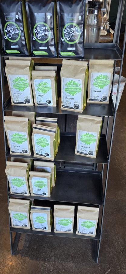 Shelves of Savaya coffee bags, including the Singer Songwriter espresso.