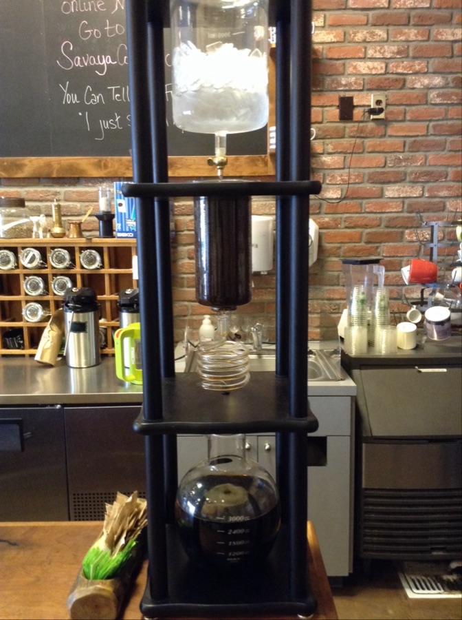 A cold-brew tower slowly dripping coffee at the bar.